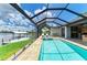 Enjoy the enclosed pool and spa overlooking the water with ample space for sunbathing and lounging at 15498 Seafoam Cir, Port Charlotte, FL 33981