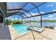 Stunning screened pool and spa offers serene lake views with plenty of room for entertaining Gathering and friends at 15498 Seafoam Cir, Port Charlotte, FL 33981