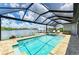Relaxing screened-in pool and spa overlooking a serene lake view perfect for enjoying sunny days at 15498 Seafoam Cir, Port Charlotte, FL 33981