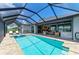 Expansive lanai featuring a beautiful pool, spa, outdoor seating, and bar area, perfect for entertaining at 15498 Seafoam Cir, Port Charlotte, FL 33981