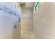 Elegant walk-in shower with tiled walls, a rainfall showerhead, and designer accents for a spa-like experience at 15498 Seafoam Cir, Port Charlotte, FL 33981