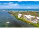 Aerial view of condos near the water, featuring a pool, dock, and picturesque scenery, ideal for waterfront living at 1701 Beach Rd # 207, Englewood, FL 34223
