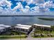 Aerial view of condos showcasing water views, palm trees, and landscaping that makes the property an oasis at 1701 Beach Rd # 207, Englewood, FL 34223