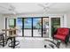 Balcony view with glass doors overlooking the water and an outdoor patio seating area at 1701 Beach Rd # 207, Englewood, FL 34223
