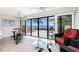Balcony view with glass doors overlooking the water and an outdoor patio seating area at 1701 Beach Rd # 207, Englewood, FL 34223