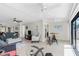 Living room with a bar table and chairs next to glass doors, allowing access to the balcony at 1701 Beach Rd # 207, Englewood, FL 34223
