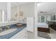 Stylish bathroom boasts a blue countertop vanity and gold fixtures, offering a luxurious feel at 1701 Beach Rd # 207, Englewood, FL 34223