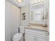 Bathroom featuring a shower with curtain, toilet, and vanity with gold hardware at 1701 Beach Rd # 207, Englewood, FL 34223