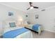 Charming bedroom offering two beds, a ceiling fan, and tasteful wall decor at 1701 Beach Rd # 207, Englewood, FL 34223