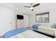 Well-lit bedroom showcasing twin beds, a ceiling fan, and ample closet space at 1701 Beach Rd # 207, Englewood, FL 34223
