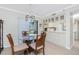 Bright dining area with glass table, seating for four, and sliding glass doors to the balcony at 1701 Beach Rd # 207, Englewood, FL 34223