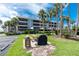 View of waterfront condos featuring a picnic area and grilling station for residents in a picturesque setting at 1701 Beach Rd # 207, Englewood, FL 34223