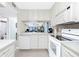 Open-concept kitchen boasts views of the living area and waterfront beyond at 1701 Beach Rd # 207, Englewood, FL 34223
