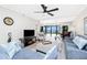 Comfortable living room with ceiling fan and a view to the balcony overlooking the water at 1701 Beach Rd # 207, Englewood, FL 34223