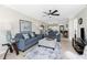 Living room with tile floors, view through to the dining area, and access to the balcony at 1701 Beach Rd # 207, Englewood, FL 34223