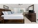 Spacious main bedroom featuring a king bed, dresser, and a door leading to a patio at 1701 Beach Rd # 207, Englewood, FL 34223