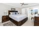 Spacious main bedroom featuring a king bed and a door leading to a patio at 1701 Beach Rd # 207, Englewood, FL 34223