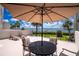 Outdoor patio area with seating, umbrella, and stunning waterfront views for relaxation at 1701 Beach Rd # 207, Englewood, FL 34223