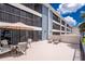 Expansive outdoor patio featuring stylish seating, sun loungers, and scenic waterfront view at 1701 Beach Rd # 207, Englewood, FL 34223