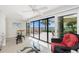 Bright sunroom featuring sliding glass doors to a patio with furniture and beach view at 1701 Beach Rd # 207, Englewood, FL 34223