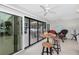 Bright sunroom featuring sliding glass doors to a patio and comfortable wicker seating at 1701 Beach Rd # 207, Englewood, FL 34223