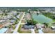 Aerial view of a neighborhood with waterfront homes and lush greenery at 1730 Bluebird Ln, Englewood, FL 34224