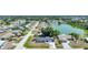 Panoramic aerial view of a suburban neighborhood with a tranquil lake and tree lined streets at 1730 Bluebird Ln, Englewood, FL 34224