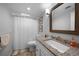 Bathroom featuring a granite vanity top, white cabinets, and shower with white shower curtain at 1730 Bluebird Ln, Englewood, FL 34224