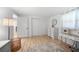 Well-lit bedroom featuring a vanity, dresser, closet, and wood-look floors at 1730 Bluebird Ln, Englewood, FL 34224