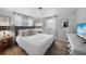 Inviting bedroom featuring a plush bed, ample lighting, and a calming atmosphere at 1730 Bluebird Ln, Englewood, FL 34224