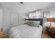 Comfortable bedroom with wood flooring, and a queen bed featuring decorative pillows and lamps at 1730 Bluebird Ln, Englewood, FL 34224