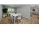 Cozy dining area featuring a white table with chairs, modern decor, and wood-look floors at 1730 Bluebird Ln, Englewood, FL 34224