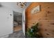 Inviting entryway featuring rustic wood accents and a glimpse into the bright, open-concept living space at 1730 Bluebird Ln, Englewood, FL 34224
