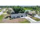 Aerial view of a single-Gathering home featuring a well-manicured lawn and beautiful mature trees at 1730 Bluebird Ln, Englewood, FL 34224