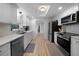 Modern kitchen featuring stainless steel appliances, sleek countertops, and ample cabinet space with a skylight at 1730 Bluebird Ln, Englewood, FL 34224