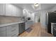 Bright kitchen featuring stainless steel appliances, sleek countertops, and ample cabinet space with a skylight at 1730 Bluebird Ln, Englewood, FL 34224