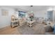 Sunlit living room boasts neutral tones, with cozy seating, a decorative rug and stylish decor accents at 1730 Bluebird Ln, Englewood, FL 34224