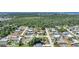 Aerial view of a residential neighborhood surrounded by lush green forest at 1730 Bluebird Ln, Englewood, FL 34224