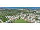 Scenic aerial view of a coastal community with lush greenery and distant ocean views at 1730 Bluebird Ln, Englewood, FL 34224