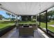 A covered patio with outdoor furniture, a fire pit and a view of the backyard at 1730 Bluebird Ln, Englewood, FL 34224