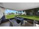 Cozy patio with four cushioned chairs, a small table and a view of the backyard at 1730 Bluebird Ln, Englewood, FL 34224