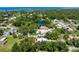 Aerial view of a home with lush landscaping, a pond, and located near the ocean at 1733 Belvidere Rd, Englewood, FL 34223
