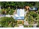 Aerial shot showcases the home's unique roof design and meticulously landscaped surroundings at 1733 Belvidere Rd, Englewood, FL 34223