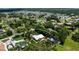 Aerial view of home with lush landscaping showing mature trees and nearby neighborhoods at 1733 Belvidere Rd, Englewood, FL 34223