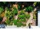 Aerial view of a lush and landscaped backyard highlighting a decorative patio and walkway at 1733 Belvidere Rd, Englewood, FL 34223