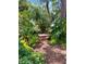 Scenic backyard path surrounded by lush greenery, creating a private and tranquil retreat at 1733 Belvidere Rd, Englewood, FL 34223