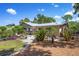 Landscaped backyard featuring a patio, lush greenery, and serene outdoor space at 1733 Belvidere Rd, Englewood, FL 34223