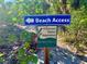 Beach access sign with protected native vegetation to the sandy beach at 1733 Belvidere Rd, Englewood, FL 34223