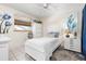 This bedroom features a ceiling fan, tile floor, and a bright window providing natural light at 1733 Belvidere Rd, Englewood, FL 34223