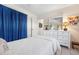 This bedroom has a dresser with a large mirror and stylish blue curtains at 1733 Belvidere Rd, Englewood, FL 34223